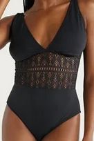 Black one piece bathing suit with a v-neck and crochet cut out 