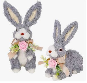 A set of two grey straw rabbit figurines with flowers.